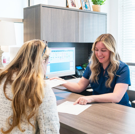 A Deeper Healing patient care coordinator reviewing the Stay + Heal plan with a traveling patient